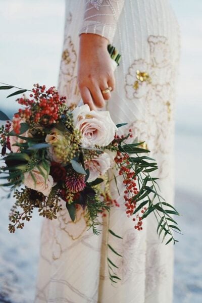 Elegant wedding bouquet with pink roses and greenery at Mountain Harbour beach location.