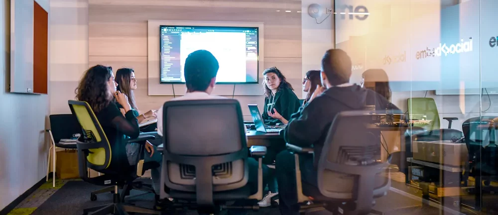 Fractional CMO presenting marketing strategy to executive team during board meeting.