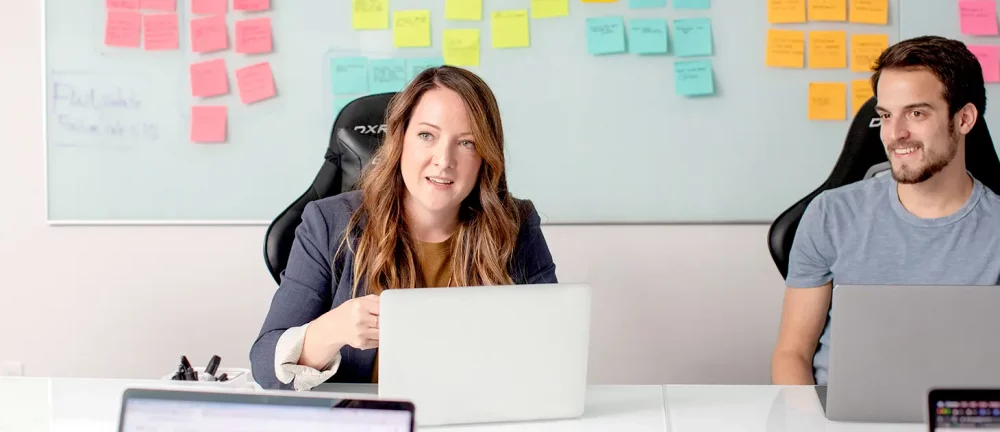 Marketing team collaborating on fractional CMO strategy with sticky notes and campaign planning.