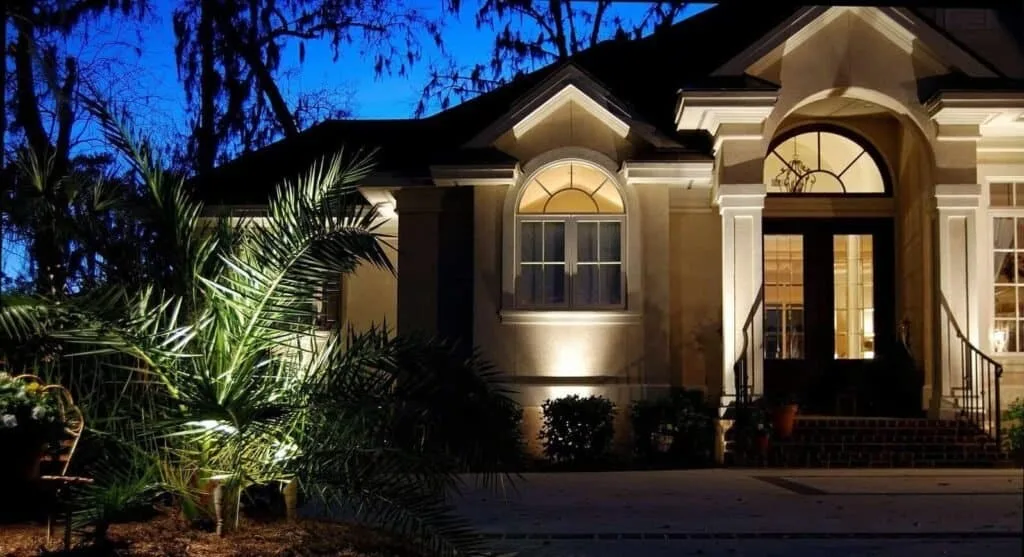 Beautifully illuminating a luxurious Hilton Head home exterior at night with landscape lighting.