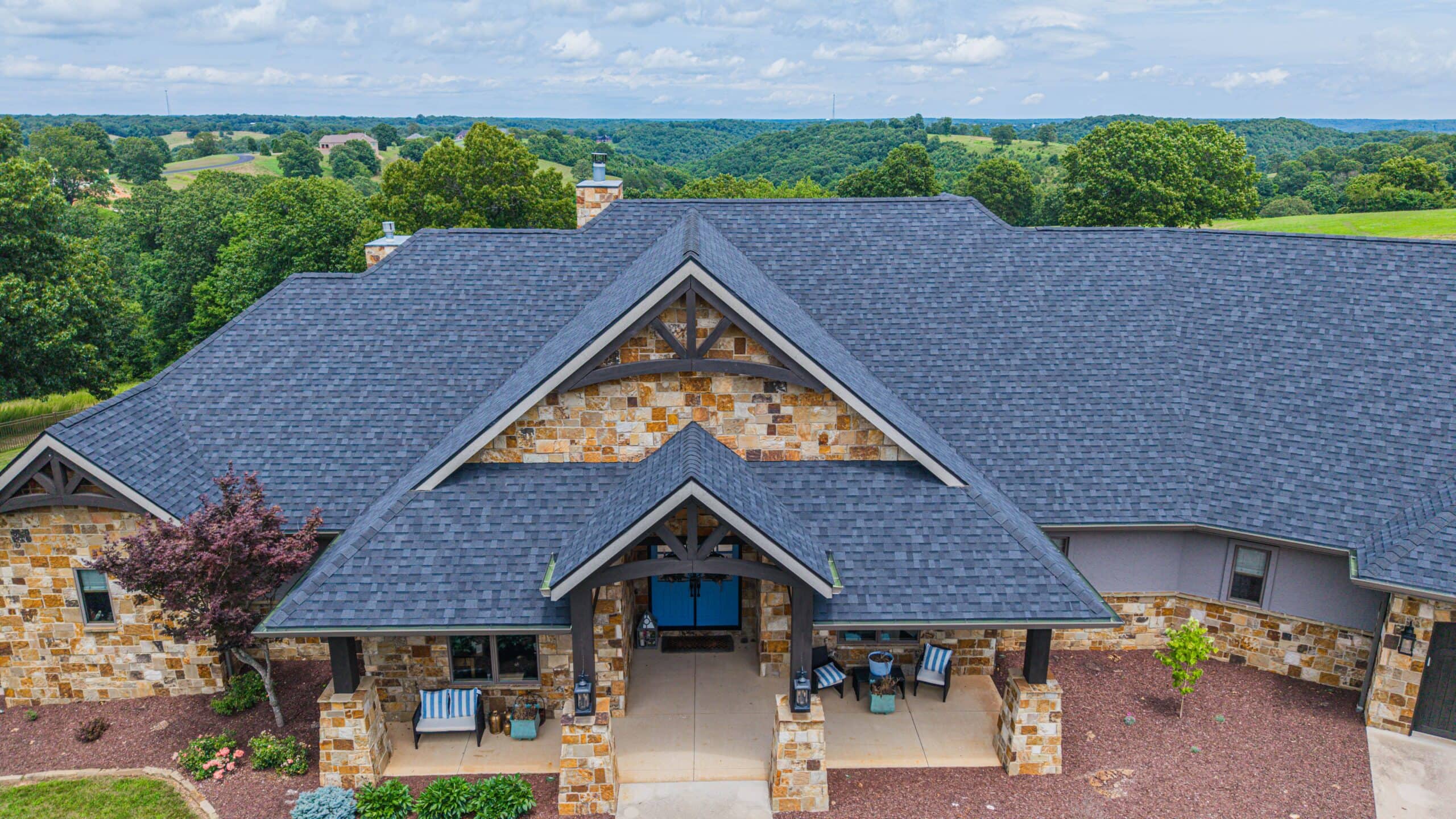 Beautiful residential roof with durable shingles in a scenic suburban setting.