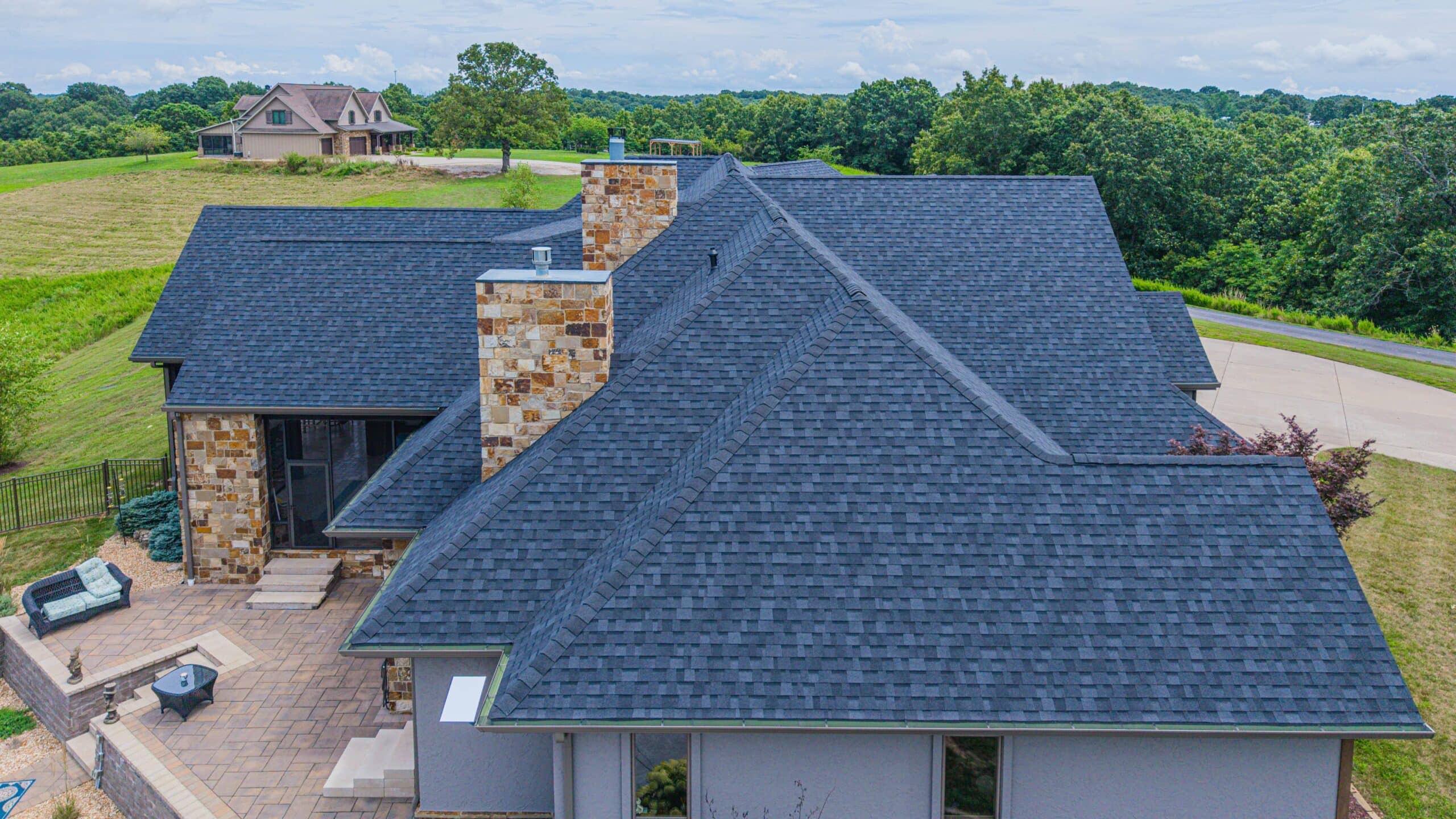 High-quality asphalt shingle roofing on a spacious Midwest home, showcasing durability and style for.