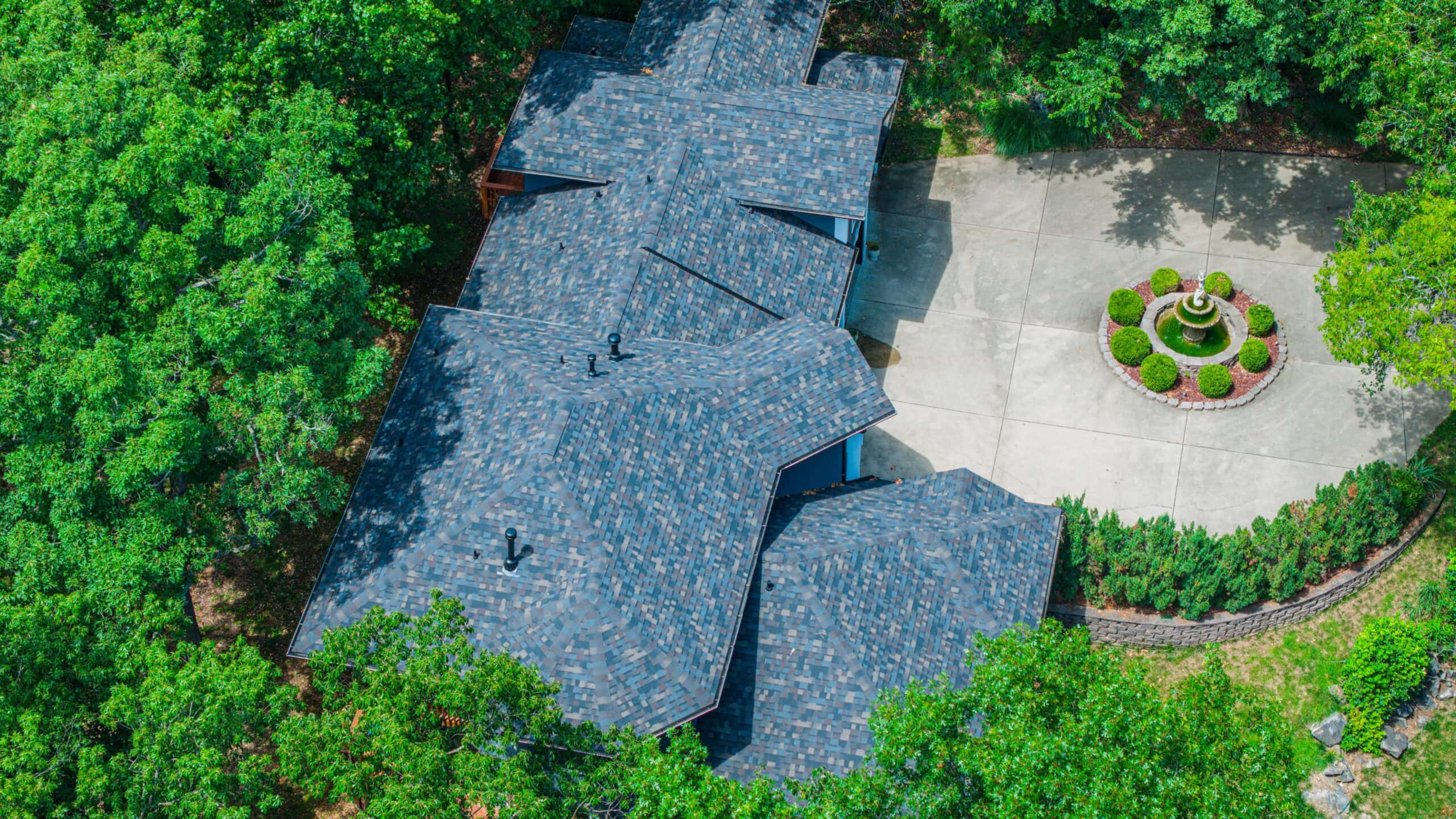 Roofing installation featuring durable blue shingles on a residential home.