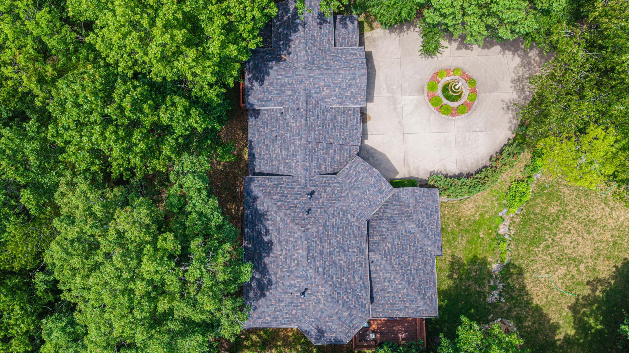 High-quality roofing installation by Midwest Roofing in a lush, green residential setting.