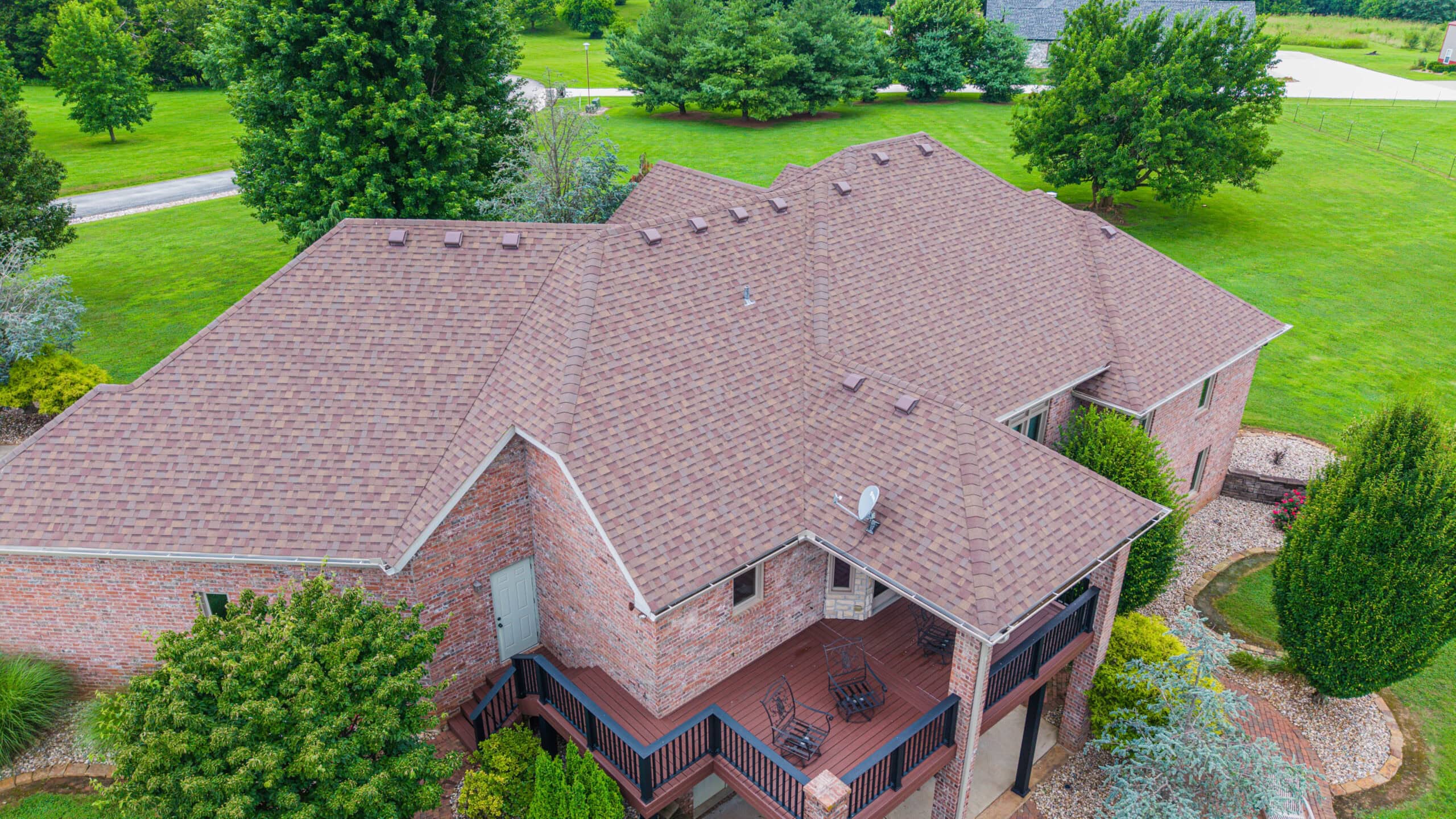 Aerial view of a residential roof with new asphalt shingles installed by Midwest Roofing.