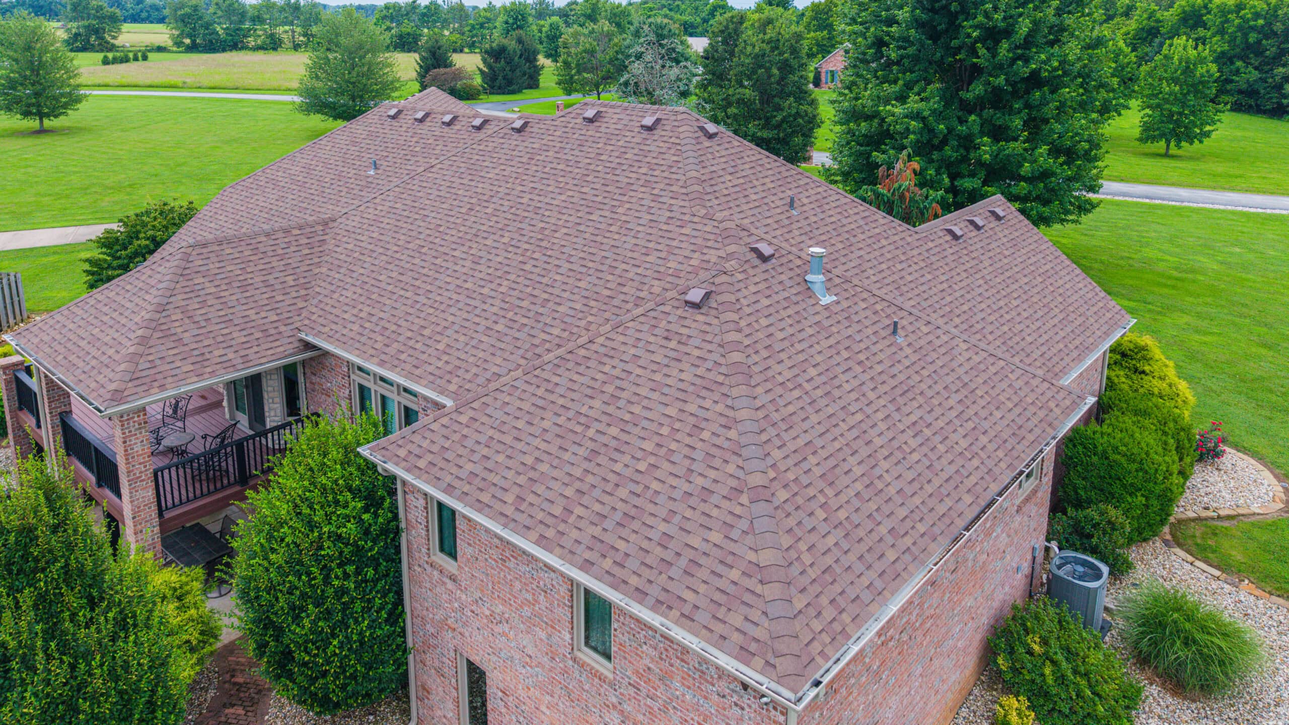 Expert residential roofing by Midwest Roofing in a lush green neighborhood.