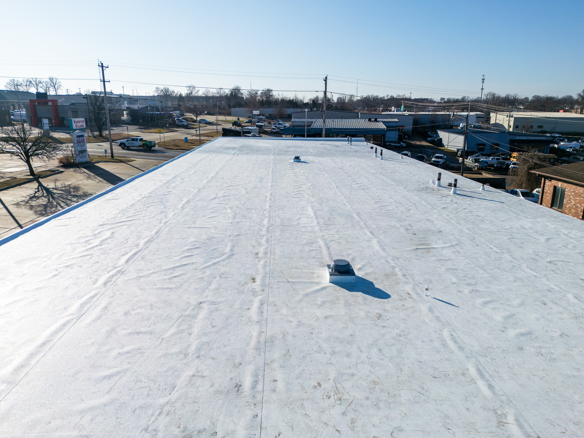 Flat commercial roofing with new coating in Columbia, MO for roofing durability.