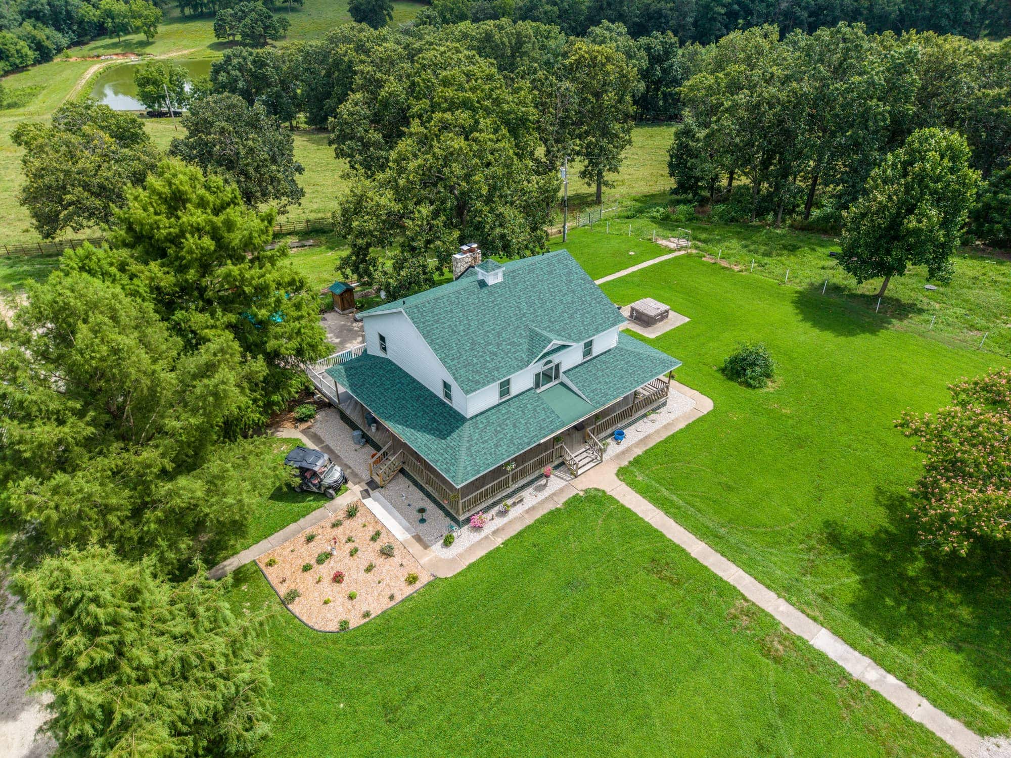 Aerial view of a house with a new green roof in Dixon, MO.