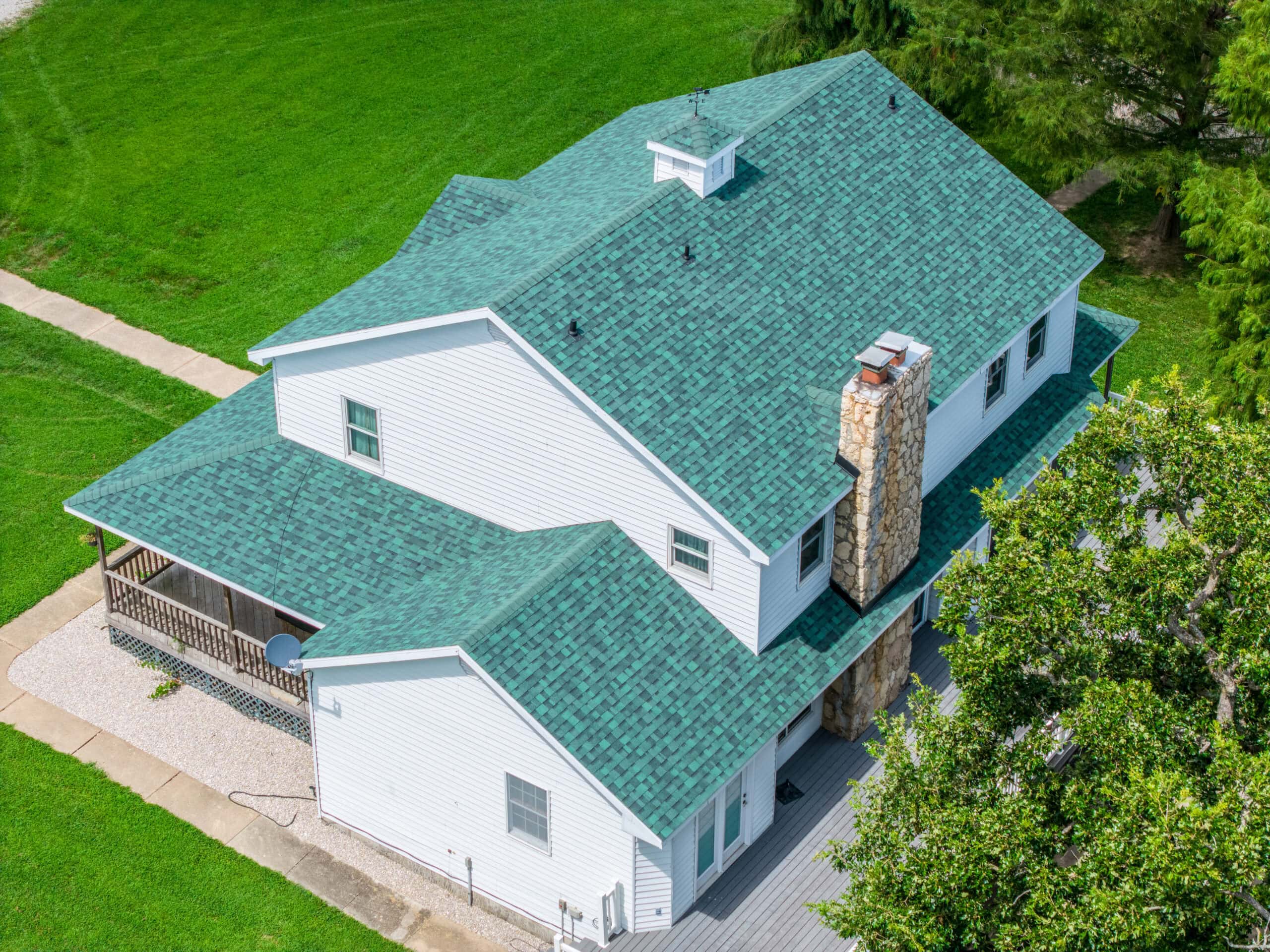 New green asphalt shingle roof on a residential home in Dixon, MO.