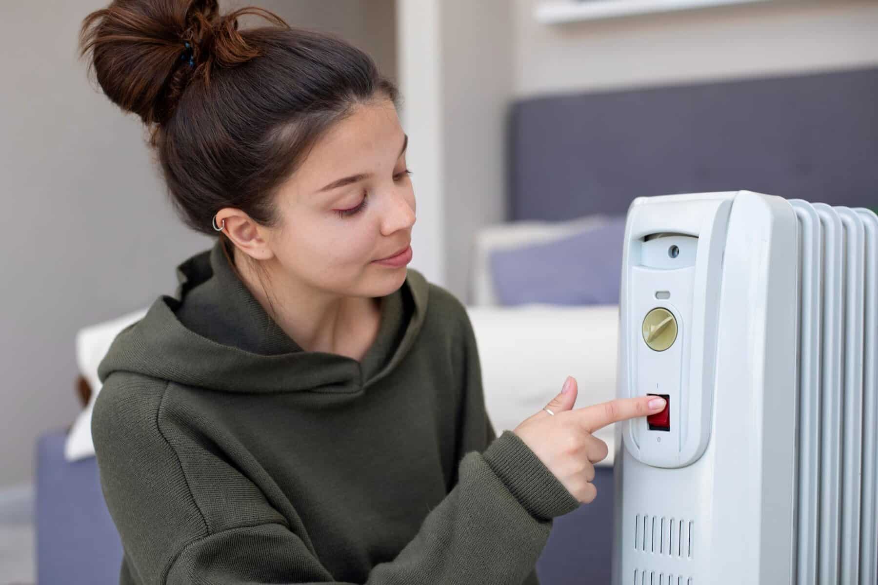 FEMALE USING HEATER INDOORS, HVAC AND PLUMBING SERVICES, ENERGY EFFICIENCY, COMFORT, MODERN HOME HVAC SYSTEM, HEATING SOLUTIONS, MY Jockey top-rated HVAC and plumbing.
