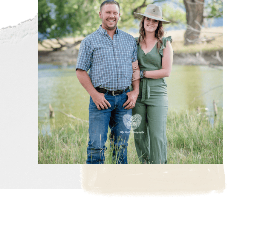 Smiling couple outdoors by lake, enjoying nature, during professional portrait photo shoot for engagement or couple photography services.