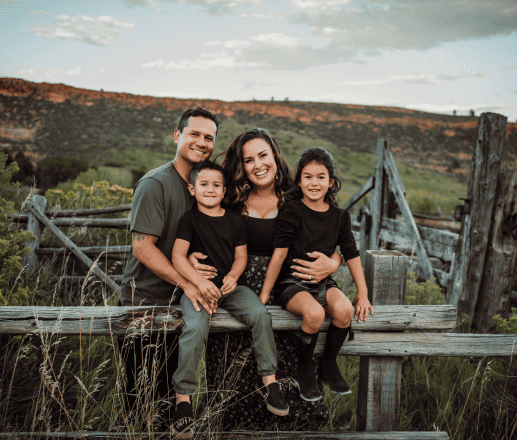 Happy family outdoor portrait in scenic rural landscape, capturing joyful moments for family photography, portrait photography, and outdoor photoshoot sessions.