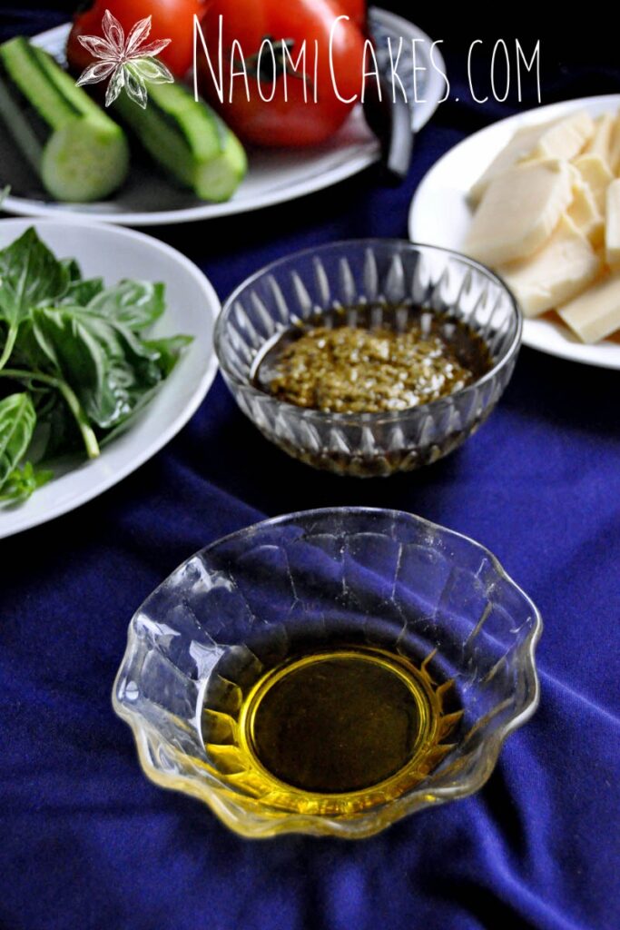 olive oil with salad ingredients on a blue tablecloth