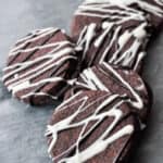 round chocolate sugar cookies drizzled with dark and white chocolate