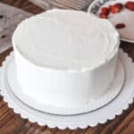 smooth buttercream frosted cake on a turntable