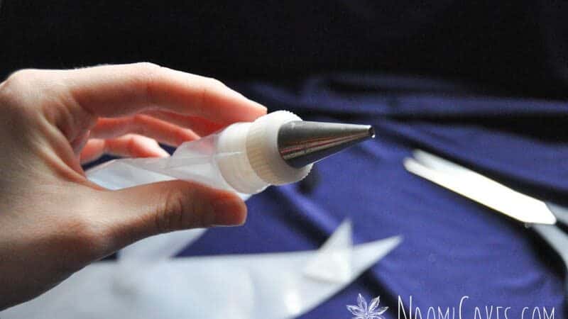 hand holding an empty piping bag fitted with coupler and tip