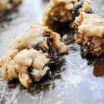 broken open fudgey cookie on a cookie sheet