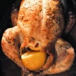 roasted chicken stuffed with lemon and sprinkled with rosemary