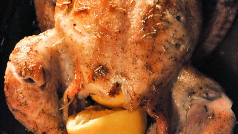 roasted chicken stuffed with lemon and sprinkled with rosemary