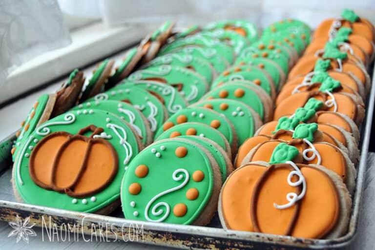 a cookie sheet lined with rows of sugar cookies decorated for fall