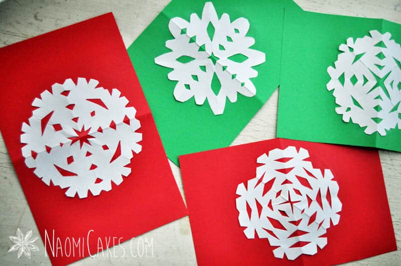 red and green homemade Christmas cards with snowflakes on them