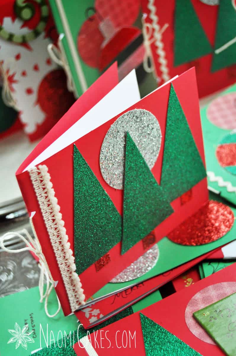 a red homemade Christmas card with trees and a glitter silver moon on it