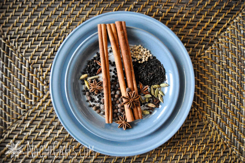 chai spices on two blue plates on a basket tray