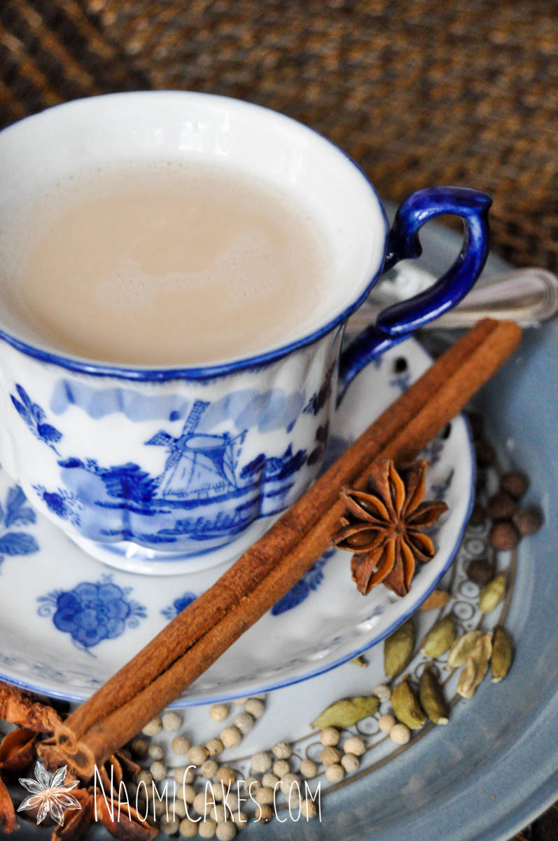 close up image of a blue china tea cup of chai tea with cinnamon stick and star anise