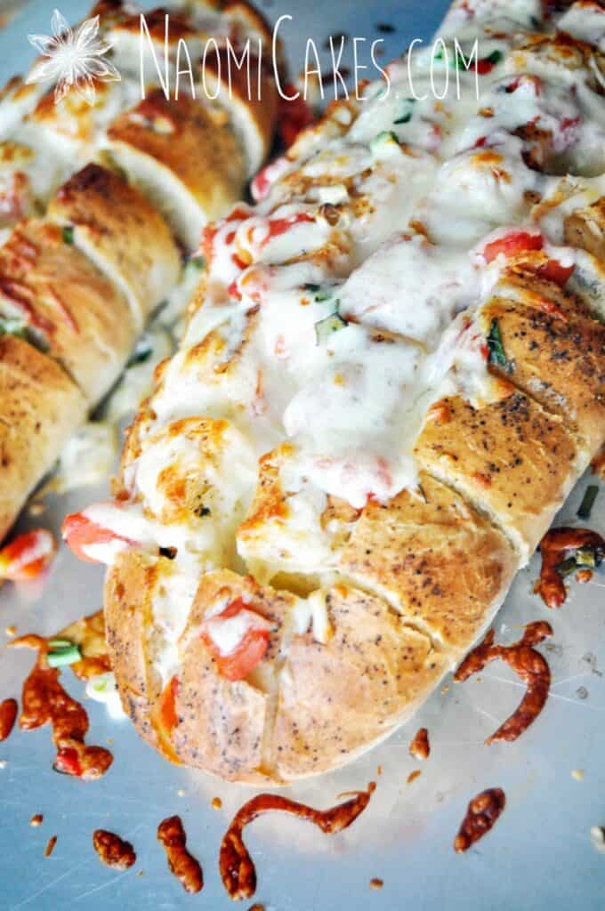 cheesy stuffed garlic bread right out of the oven on a pan