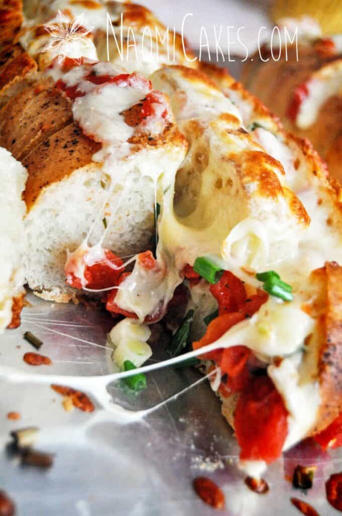 inside of a loaf of cheesy stuffed garlic bread on a cookie sheet