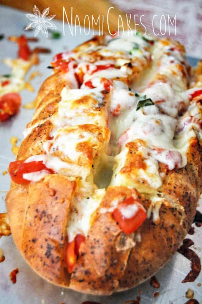 cheesy stuffed garlic bread on a pan