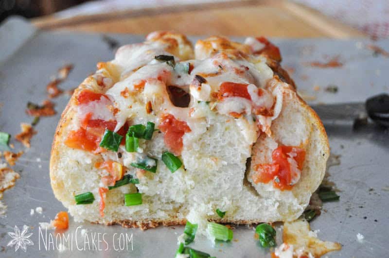 side view of a cut open piece of stuffed garlic bread
