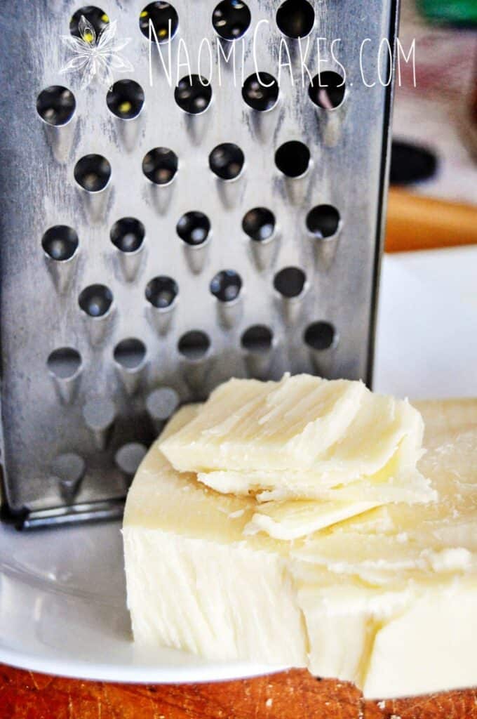 mozzarella cheese and a box grater behind it