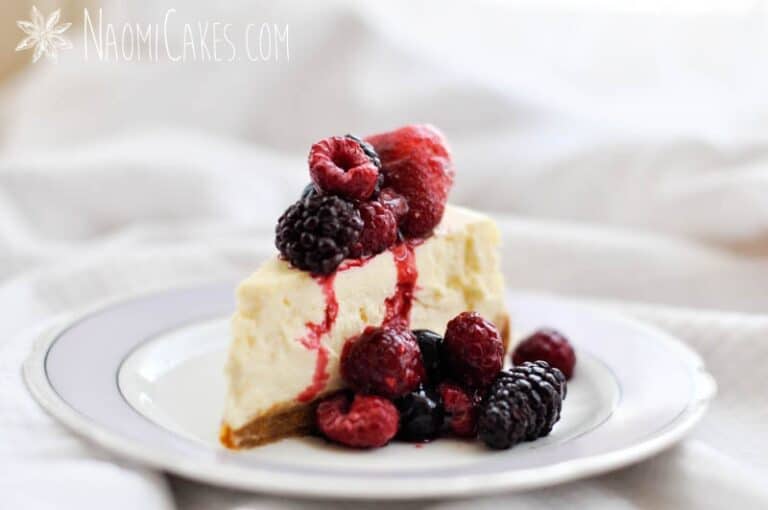 horizontal image of cheesecake with frozen fruit on top