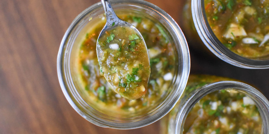 3 jars of fresh green chile with a spoon showing what it looks like