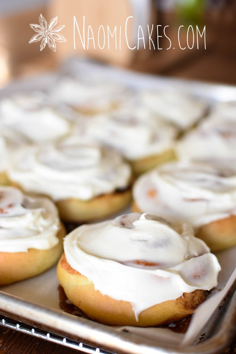 frosted cinnamon rolls on the pan after baking