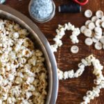 popcorn, garland, buttons, thread, scissors, and pin cushion