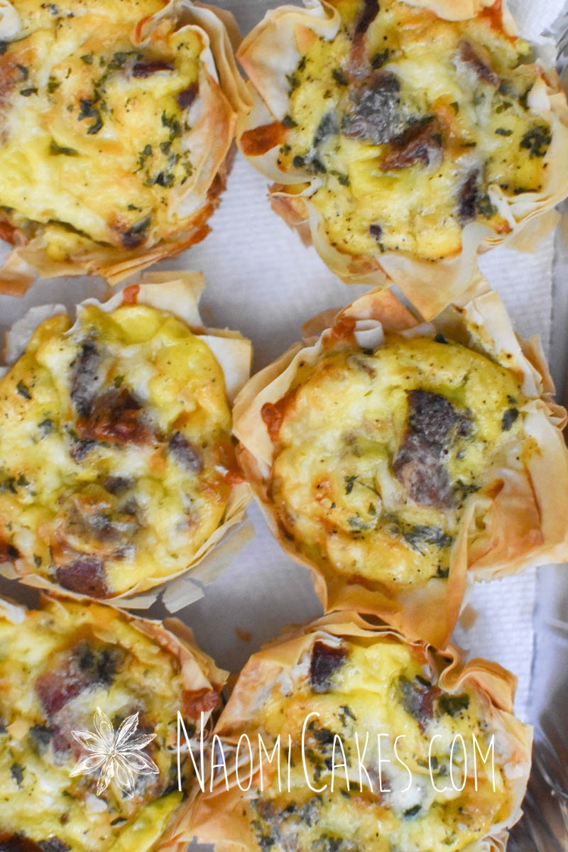 miniature quiche tarts with bacon and cheddar on paper towel
