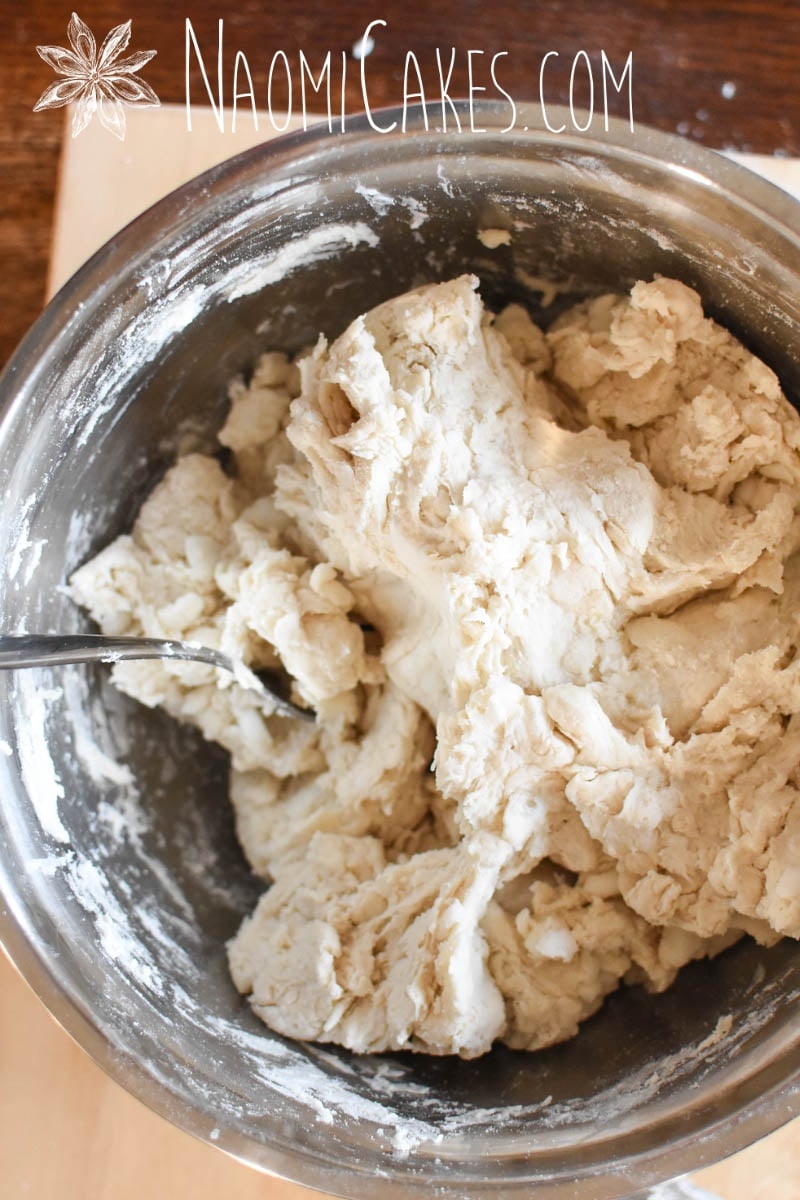 shaggy pastry dough in a metal bowl