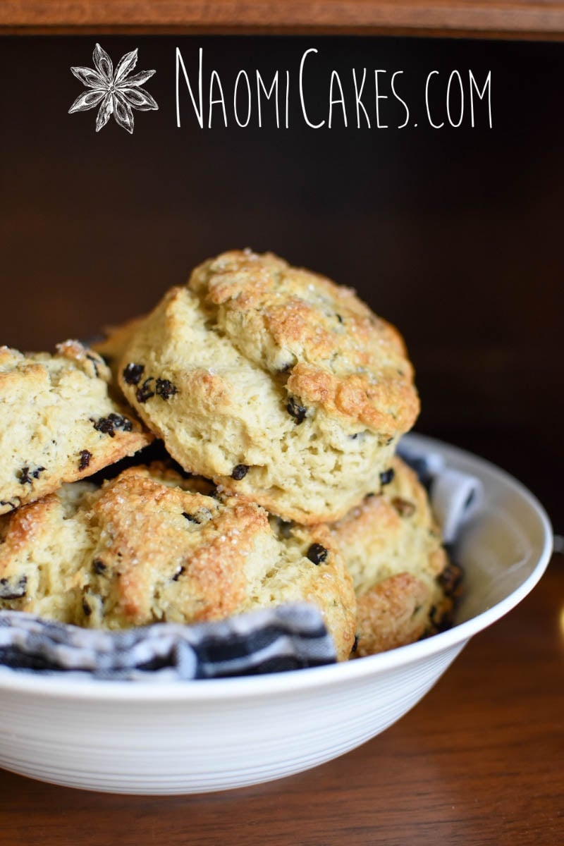 flaky scones close up with currants in a glass bowl