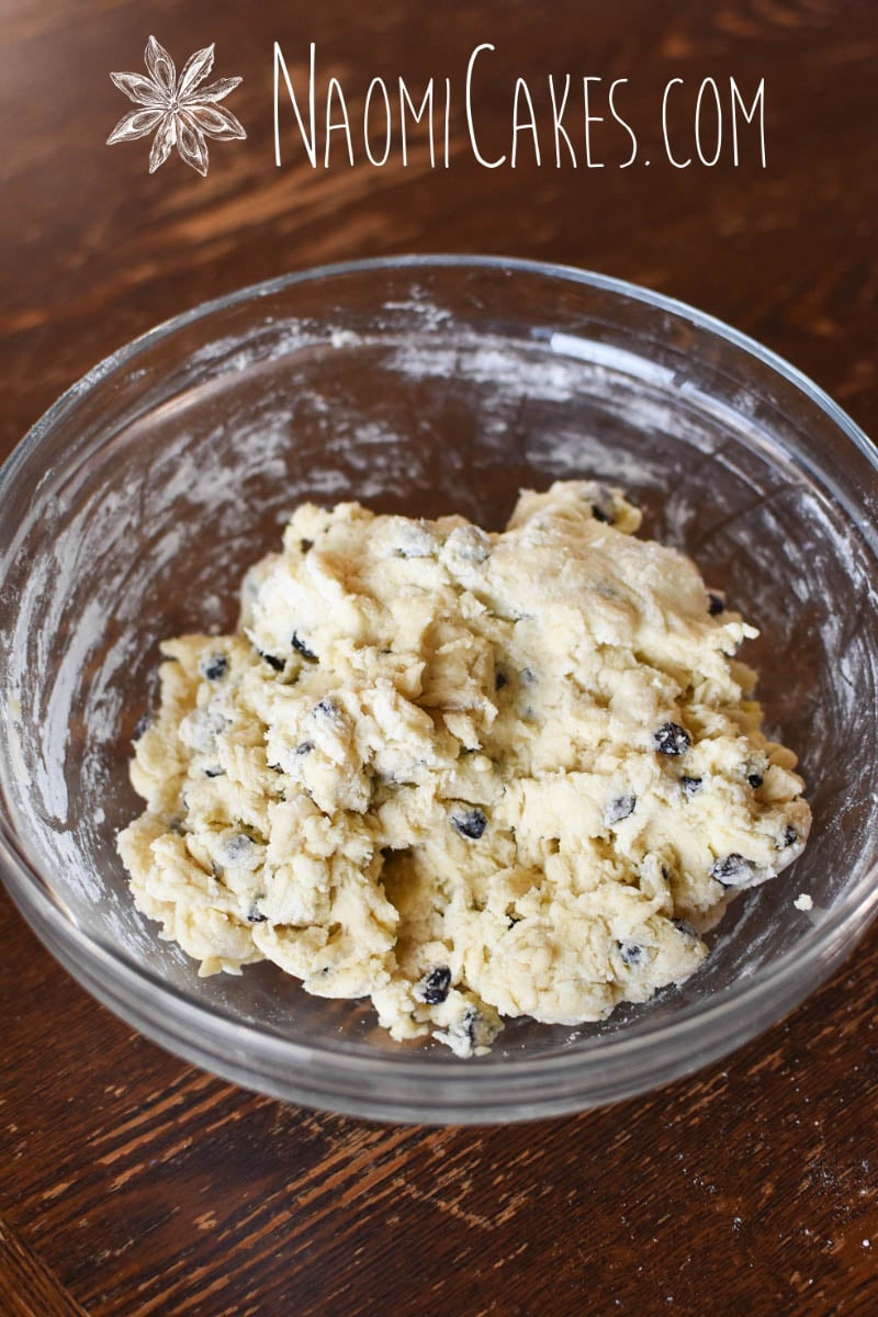 rough scone dough in a glass bowl on a wooden table