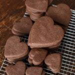 chocolate heart shaped cookies on a cooling rack