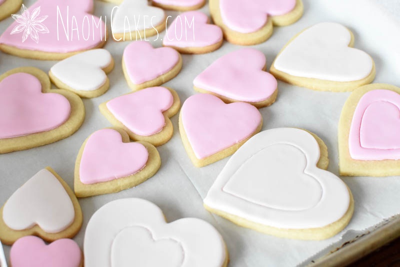 pink and white heart shaped cookies with fondant heart imprints on them