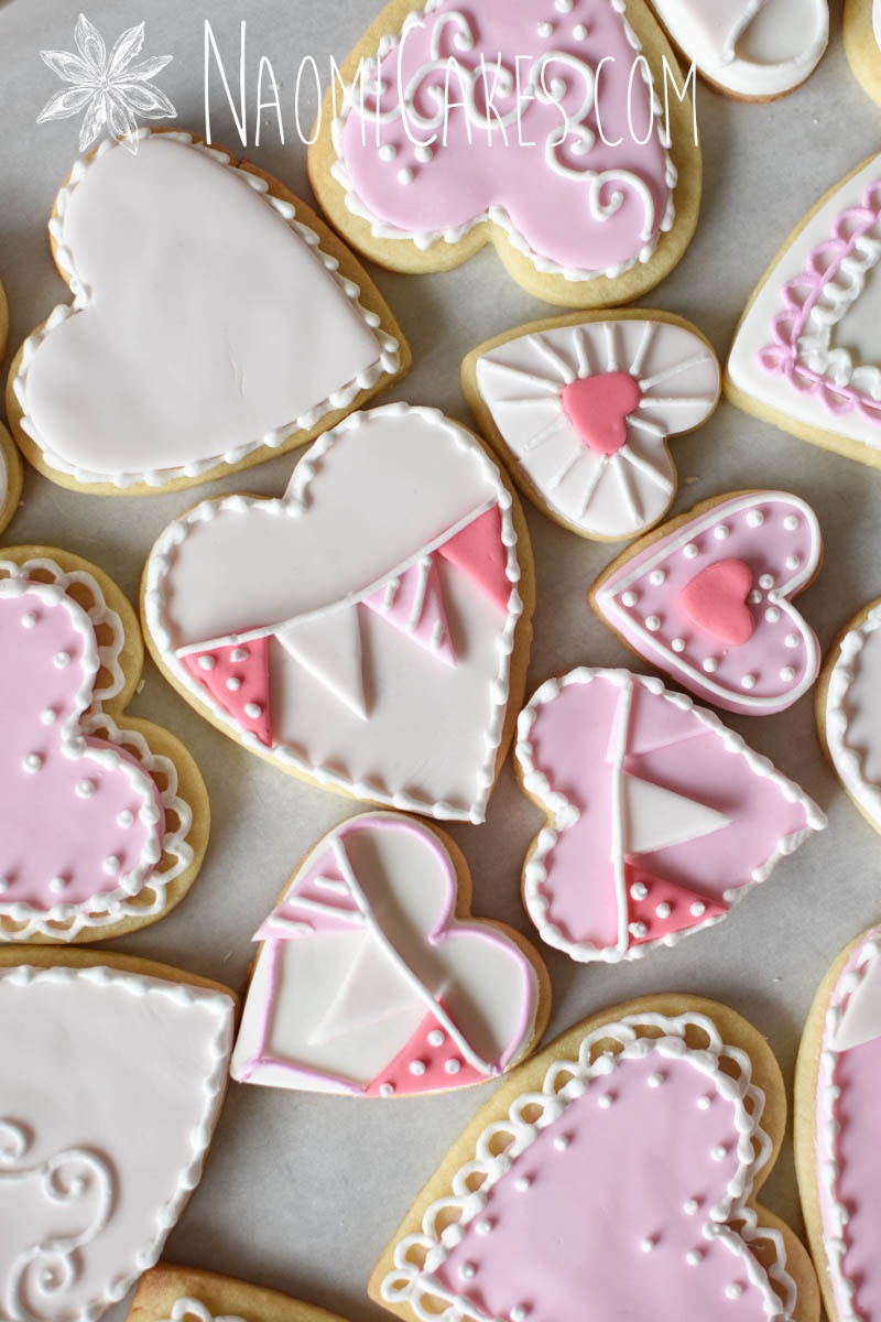 festive pink and white heart cookies decorated with fondant