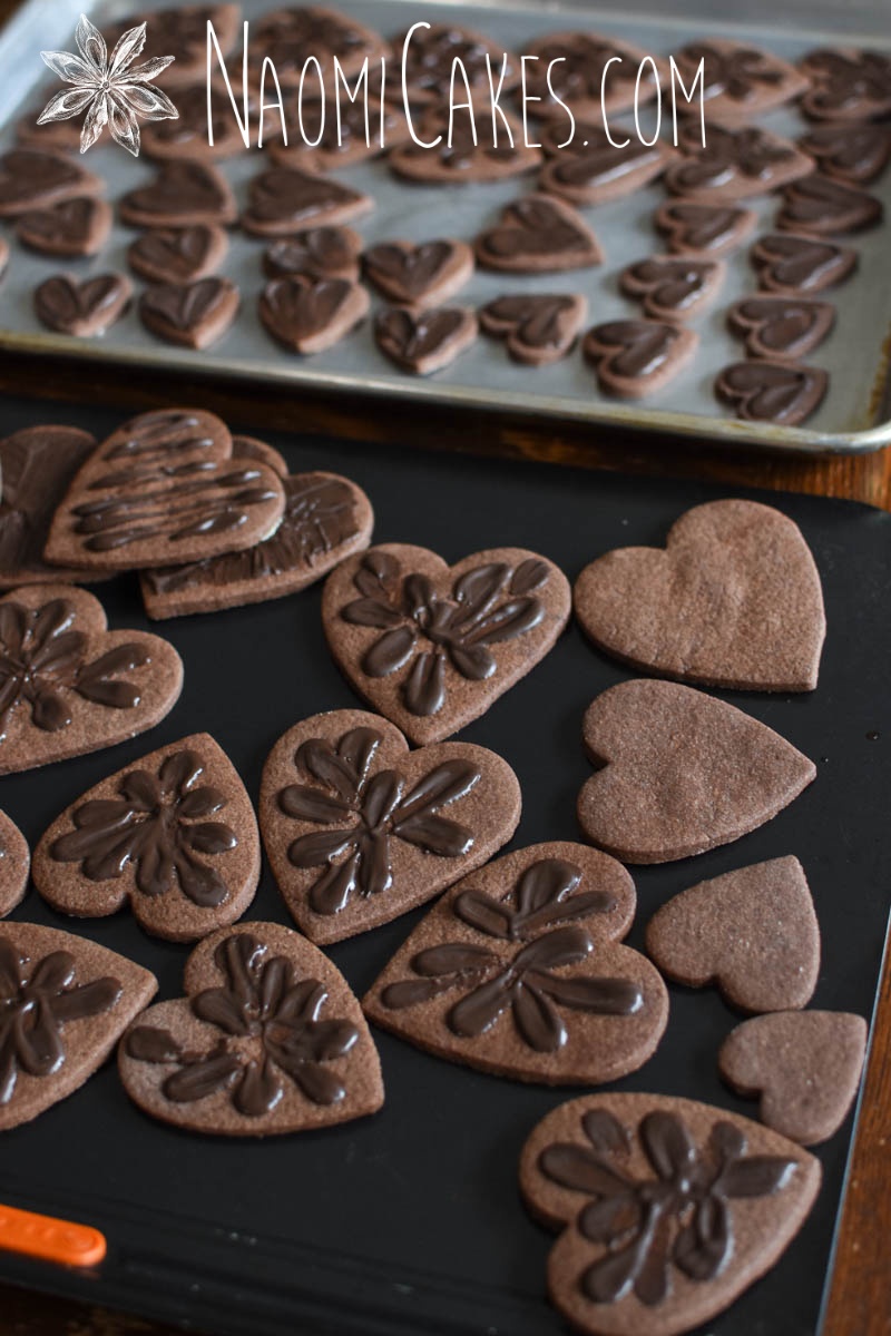 chocolate heart shaped sugar cookies with chocolate decoration on some of them and not on others