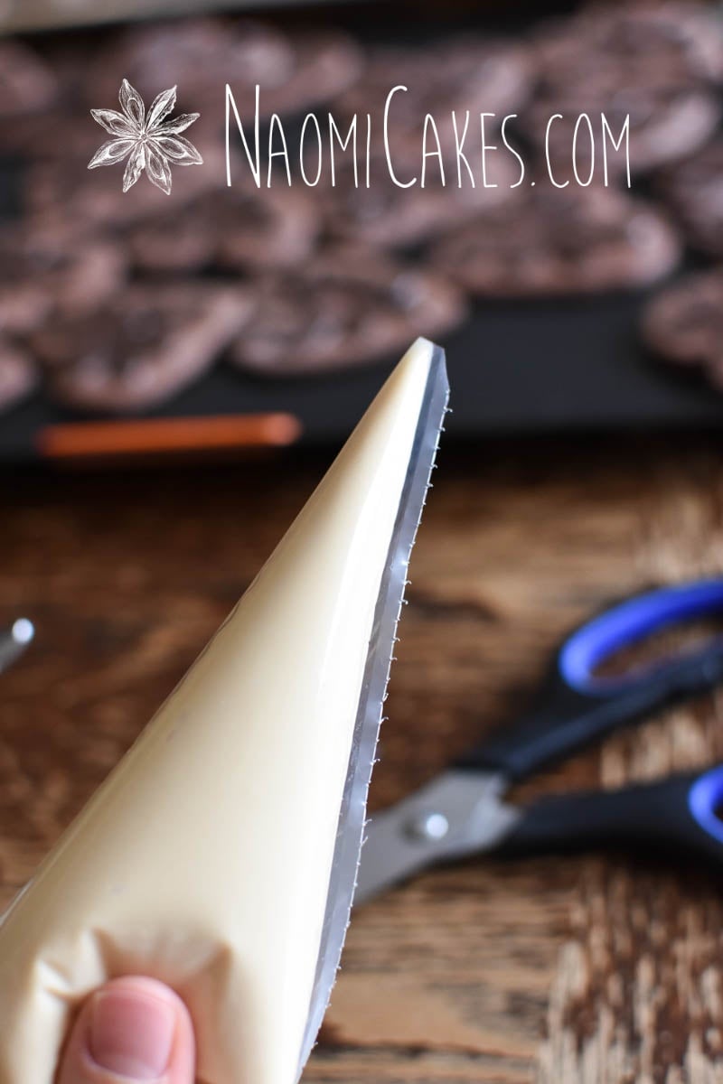 white chocolate in a piping bag, close up with cookies in the background