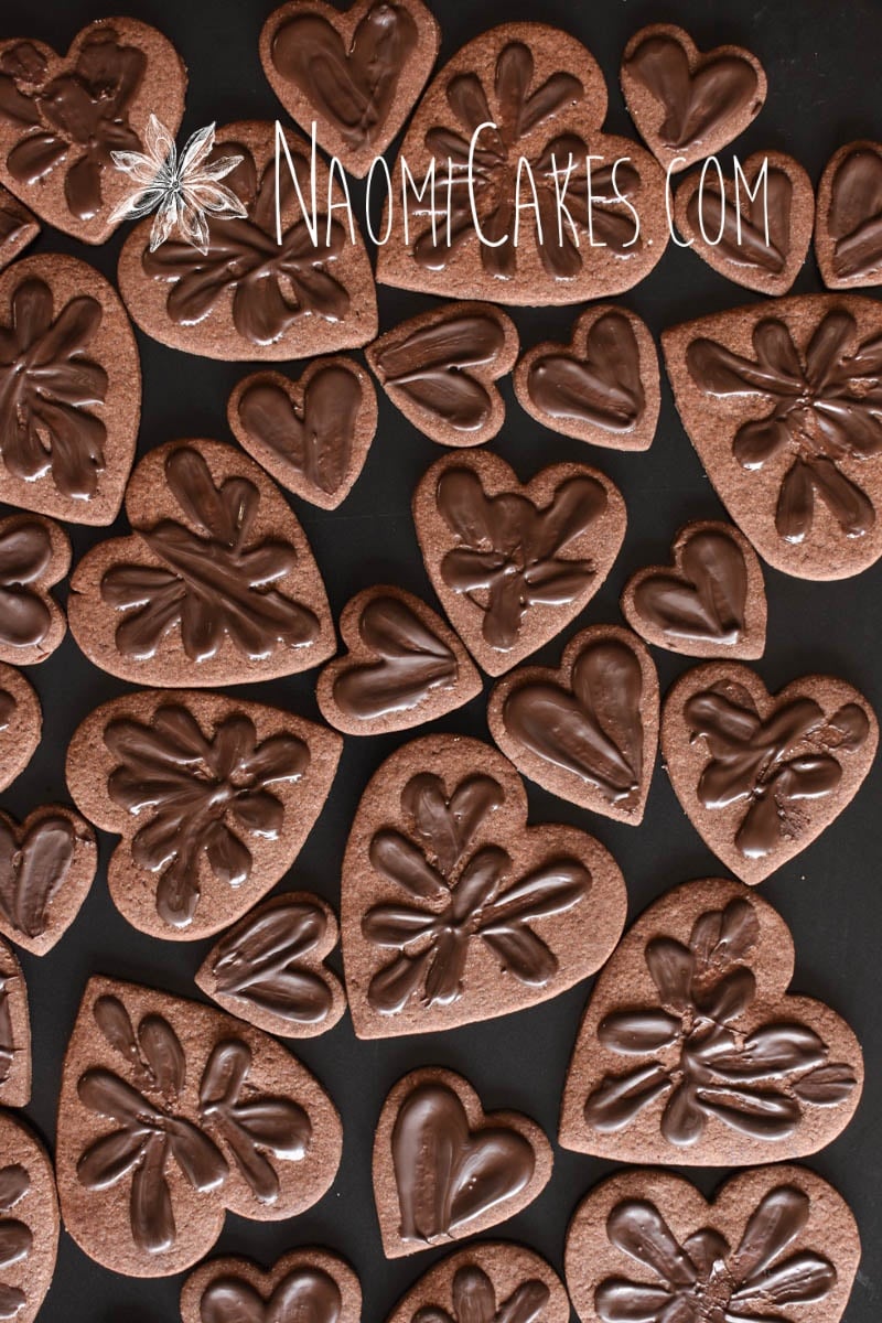 various sized chocolate heart shaped sugar cookies with chocolate smeared on top