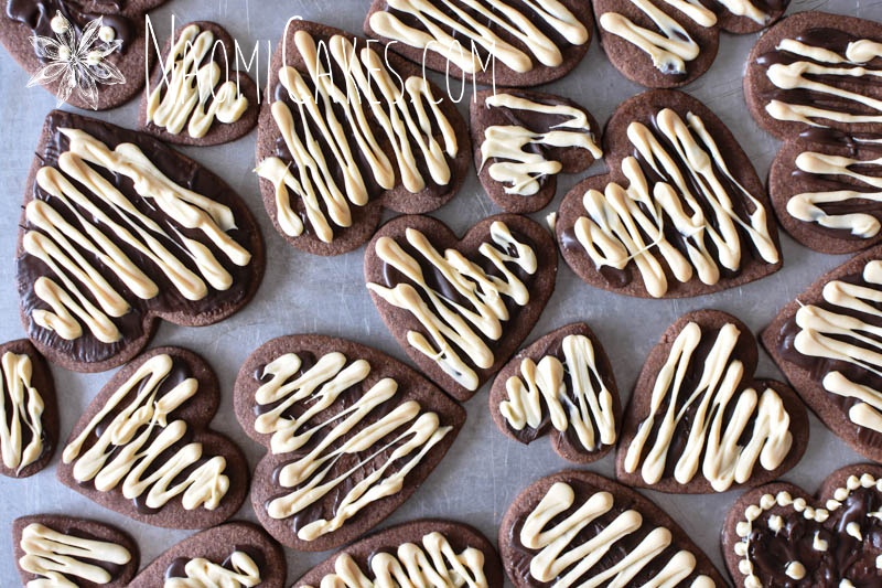 overheard view of chocolate heart shaped sugar cookies with white and dark chocolate drizzled on top