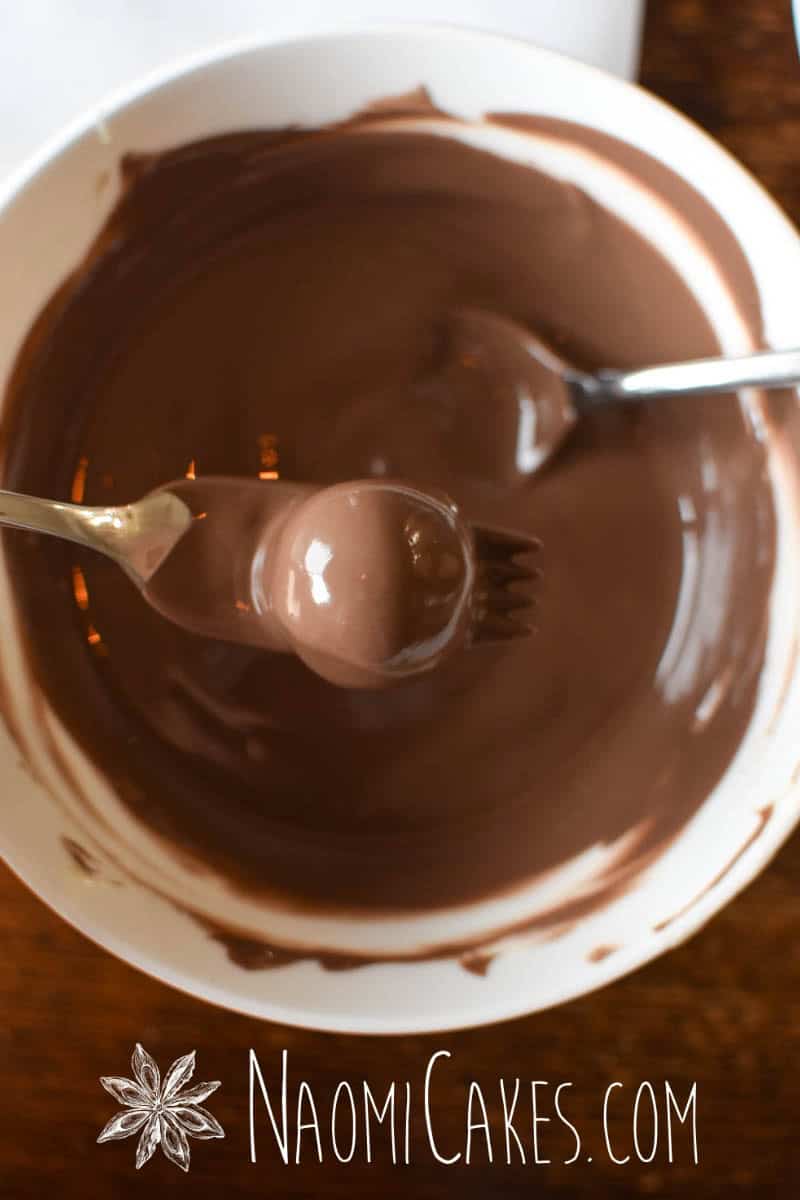 dipping a truffle in milk chocolate
