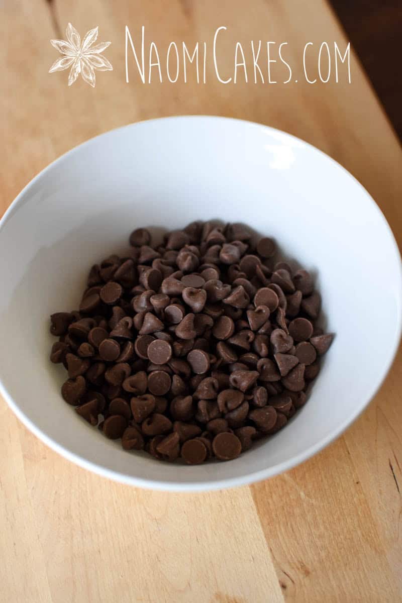 bowl of milk chocolate chips on a cutting board